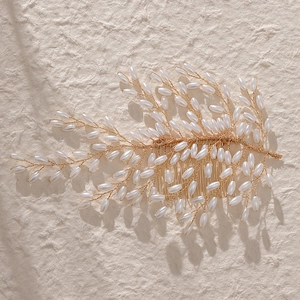 Elegant bridal hair comb with gold wires, white faux pearls, and marquise rhinestones