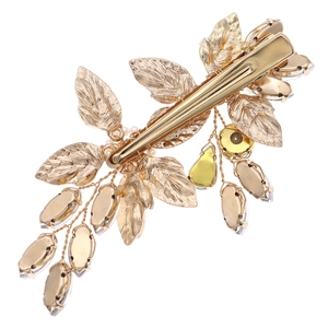 Handmade golden bridal hair clip with crystal flowers and alloy leaves on white background