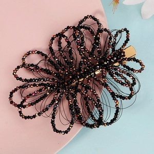Handmade black beaded flower hair clip with iridescent crystals and gold duckbill base
