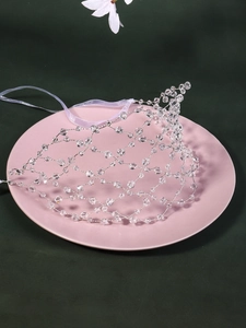 Detail of handmade crystal mesh bridal headband with silver wire and purple ribbon ties