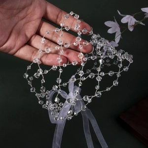 Detail of handmade crystal mesh bridal headband with elegant white organza ribbon bow
