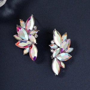Macro detail of bridal cluster earrings with AB iridescent crystals on blue background