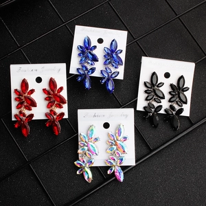 Macro view of colorful crystal leaf-shaped earrings in red, blue, black and AB stones