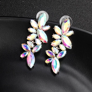 Detail of colorful AB crystal leaf tassel earrings on a textured black surface