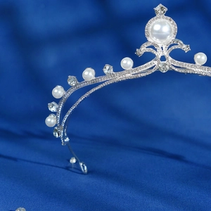 Elegant bridal crown with sparkling rhinestones and white pearls on a silver base