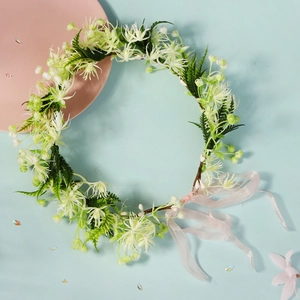 Detail view of handmade bridal floral wreath with white flowers and pink silk ribbon ties