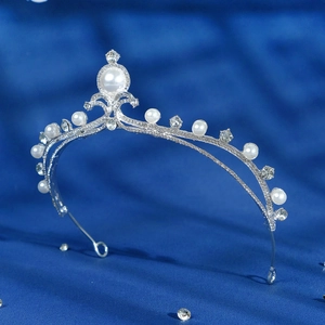 Elegant bridal tiara with white pearls and sparkling zircons on a silver alloy headband