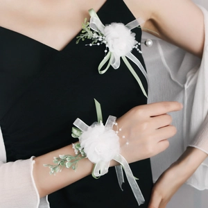 Detailed macro view of white tulle flowers with pearls and green ribbons for weddings