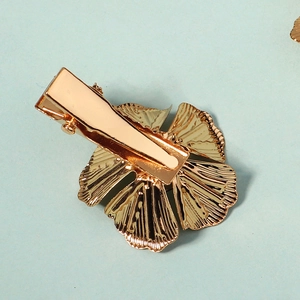 Golden flower hair clip with detailed petal texture and durable metal duckbill clip