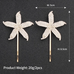 Detail view of 2-piece set of gold starfish rhinestone hair clips with dimensions