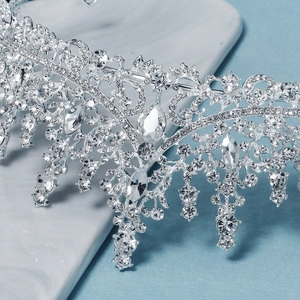 Macro shot of luxury silver bridal crown featuring intricate pear-cut crystal settings