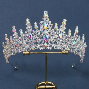 Detailed shot of luxurious bridal crown with colorful crystals on a gold jewelry stand