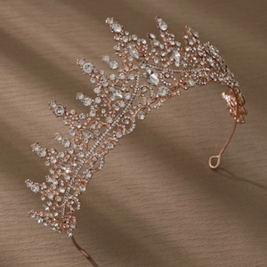Detailed side view of luxury rose gold bridal crown with shimmering white crystals
