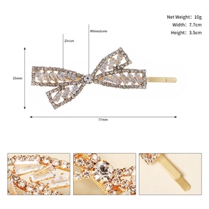Detail of elegant bow hair clip with luxury zircons and rhinestones in gold setting