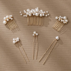 6-piece bridal hair jewelry set with gold pearl combs and pins on a warm background