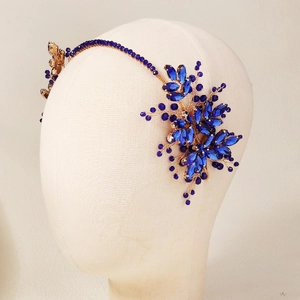 Detail of handcrafted blue crystal floral headband with gold wire and marquise stones