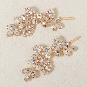 Pair of elegant gold rhinestone hair clips with crystal leaf and bow floral design