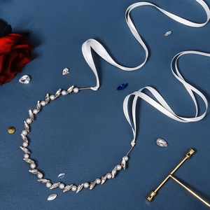 Detail of bridal headband featuring marquise crystals, pearls, and white satin ribbons