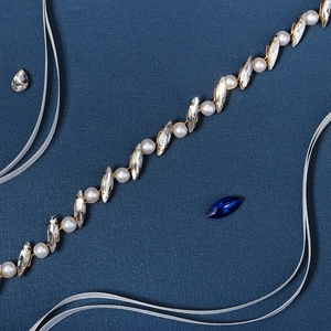 Detail of bridal hairband with white pearls and marquise rhinestones on gold setting