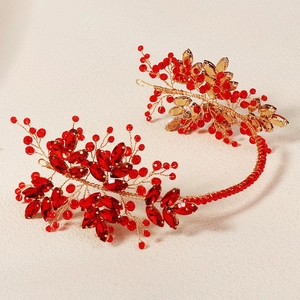 Macro detail of handmade red crystal bridal headband with gold wire floral patterns