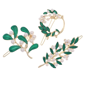 Gold leaf hair clips set with green enamel and white pearls for Christmas style