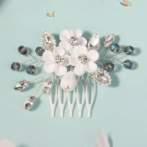 Elegant bridal hair comb with white clay flowers and crystal beads on a silver metal base