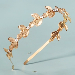 Elegante cerchietto con foglie dorate con strass luccicanti e texture in metallo