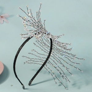 Handmade crystal beaded headband with elegant branch tassel design on blue background