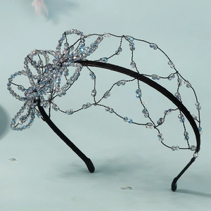 Close-up of handmade beaded butterfly headband with crystal mesh weaving and bridal design
