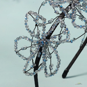 Exquisite handmade beaded flower headband with colorful aurora crystals on a slim black band