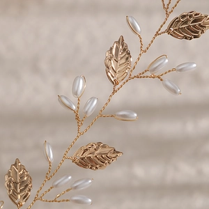 Détail de bandeau de mariée fait main en fil doré avec perles blanches et feuilles