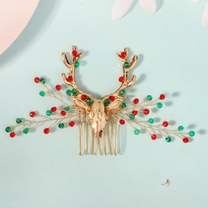 Détail du peigne de Noël en forme de renne avec perles rouges et vertes sur métal doré