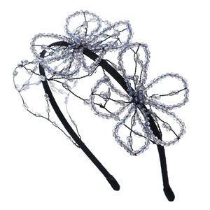 Handmade bridal headband featuring crystal beaded flower accents on a sleek black base