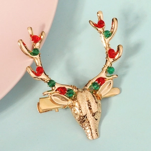 Détail de la barrette de Noël renne doré avec des perles de cristal rouge et vert
