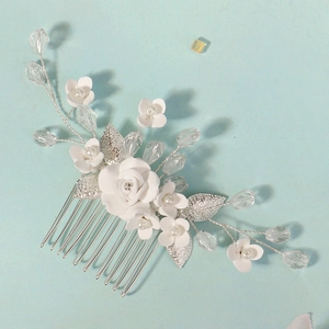Detail of bridal hair comb with white clay roses, silver leaves and crystal beads