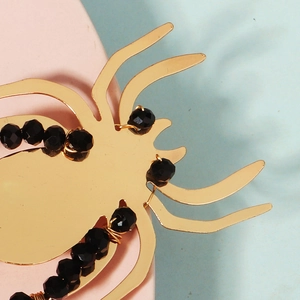 Makroansicht der goldenen Spinnen-Haarspange mit schwarzen Perlen für Halloween-Partys