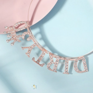 Rose gold birthday headband with rhinestone letters and crown on pink blue background