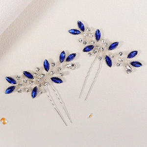 Detail of silver leaf bridal hair pin set with navy blue marquise-cut rhinestones