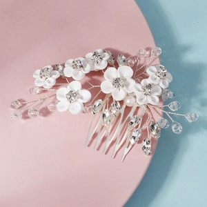 Détail d'un peigne à cheveux fleurs blanches fait main avec cristaux pour mariée
