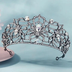 Close-up of gothic spider web crown featuring large teardrop crystals and clear rhinestones
