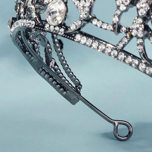 Detailed macro view of the silver crown showing intricate metal frame and rhinestone settings