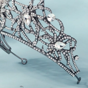 Exquisite silver bridal crown featuring rhinestones and intricate queen spider leaf patterns