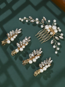 Detailed macro view of bridal hair set with gold wire leaves and pearl embellishments