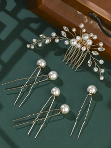 Detail of handmade gold bridal hair comb set with white pearls and crystals