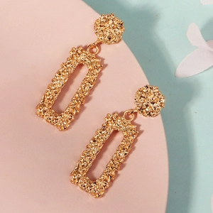 Détail de la texture de lave fondue sur ces boucles d'oreilles pendantes dorées pour femme