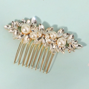 Detail of 10-tooth gold metal bridal comb with marquise rhinestones and white pearls
