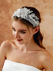 Detailed view of luxury silver bridal headband with crystal beads on an elegant bride