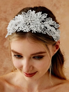Detailed view of handmade bridal headband with crystal beads and silver leaf motifs