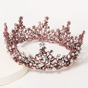 Baroque rose gold wedding crown with intricate vine patterns, pearls, and crystals