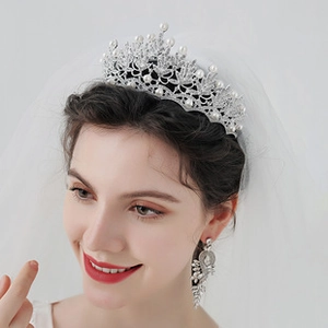 Close-up of bridal crystal tiara with white pearls and matching tassel earrings